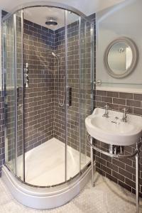 a bathroom with a shower and a sink at The George Townhouse in Shipston-on-Stour