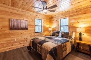 a bedroom with a bed and a ceiling fan at Adventure & Relaxation by Lake Superior in Paradise