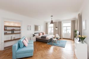 a living room with a bed and a couch at Prague Historic Center Apartments in Prague