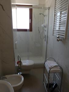 a bathroom with a shower and a sink and a toilet at Lo Scrigno in Matera