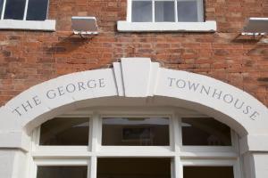 a sign over the doorway of a building at The George Townhouse in Shipston-on-Stour