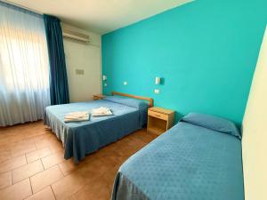 Postel nebo postele na pokoji v ubytování Hotel Timiama