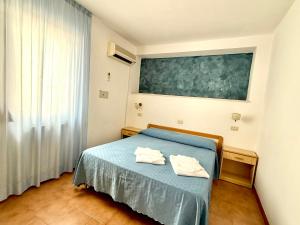 Postel nebo postele na pokoji v ubytování Hotel Timiama
