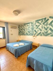 Postel nebo postele na pokoji v ubytování Hotel Timiama