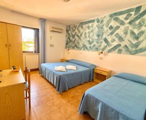 Postel nebo postele na pokoji v ubytování Hotel Timiama