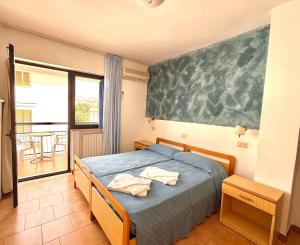 Postel nebo postele na pokoji v ubytování Hotel Timiama