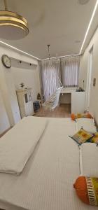 ein großes weißes Bett in einem Zimmer mit einer Uhr in der Unterkunft Shanti Niwas Jodhpur, Rajasthan in Jodhpur + 11 Fotos