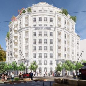 a white building with people standing outside of it at Apartment 5 in Gevgelija