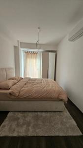 a bedroom with a bed and a window at Apartment 5 in Gevgelija