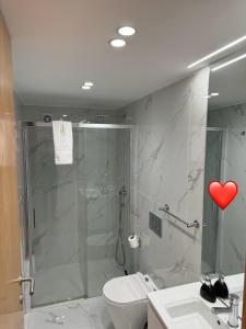 a bathroom with a shower with a heart on the wall at Romantic Douro River & Sunset views in Porto +37 photos