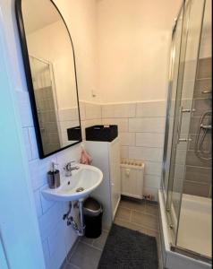 a bathroom with a sink and a shower at A&V Apartments Tiger Nähe Stadion in Gelsenkirchen
