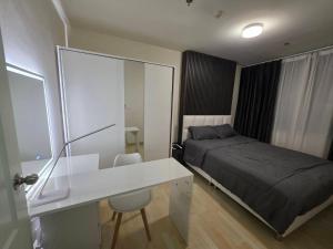 乌隆他尼Cozy bed with WiFi Pool Gym in Udon的一间卧室配有一张床和一张白色的书桌