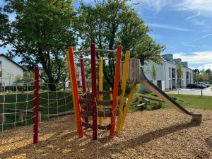 a playground with a swing set in a park at Prime Host Balcony Apartment in Karlsruhe