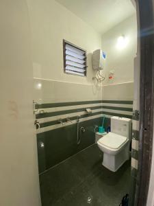 a bathroom with a toilet and a bath tub at Samendo-Retreat Homestay in Sukhia Pokhari