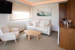a living room with a couch and a table at Hospedium Hotel A Mar in Villafranca de los Barros