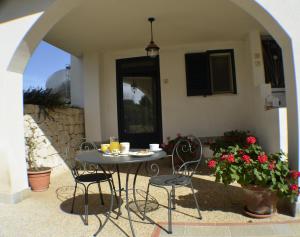 a table and chairs sitting on a patio at Masseria Asciano in Ostuni