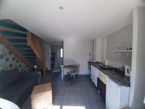 a kitchen with a counter and a dining room at Chez Clo in Grièges