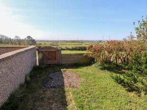 a fence with a wooden gate in a field at 11 Penygroes in Llantrisant