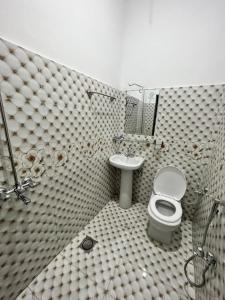a bathroom with a toilet and a sink at Sweet Villa Guest house Islamabad G9-4 in Islamabad