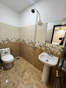 a bathroom with a toilet and a sink at Sweet Villa Guest house Islamabad G9-4 in Islamabad +8 photos