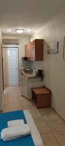 a small kitchen with a stove and a counter at Rodica Studios in Kallithea Halkidikis