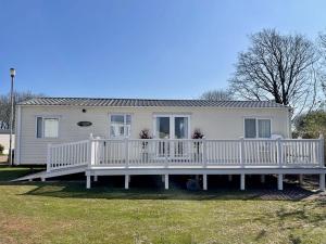 a large white house with a large deck at South Bay Hideaway, Brixham in Brixham