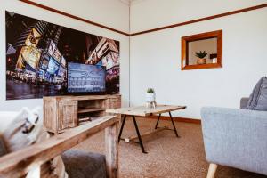 a living room with a tv and a table at Die Koffie Huis in Sutherland