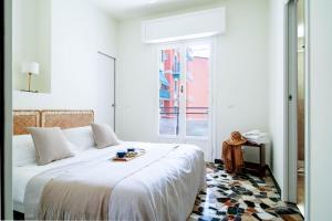 a white bedroom with a bed with a tray on it at Casa Alyx by PortofinoHomes in Santa Margherita Ligure