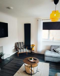 a living room with a couch and a table at Taunton Retreat in Wilton