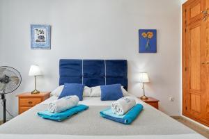 a bedroom with a large bed with two pillows on it at El Escondite in Alcaucín +24 photos