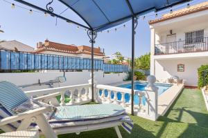 a patio with a chair and a swimming pool at El Escondite in Alcaucín