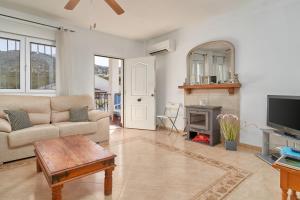 a living room with a couch and a fireplace at El Escondite in Alcaucín