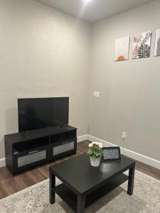 a living room with a television and a coffee table at Guest Suite in Castle Rock in Castle Rock
