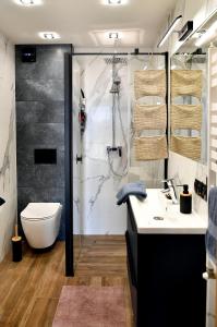 a bathroom with a shower and a toilet and a sink at Józefinka House of Energylandia Zator in Spytkowice +35 photos