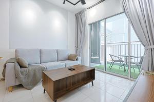 a living room with a couch and a table at Modern Studio Retreat -Prime Location Clover Home 1-03 in Brinchang