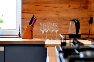 a group of wine glasses sitting on a counter at Józefinka House of Energylandia Zator in Spytkowice