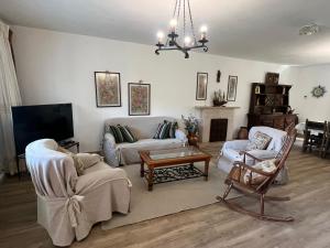 a living room with two couches and a tv at Gestiona2R- Casa con finca para desconectar cerca de la playa in Llanes