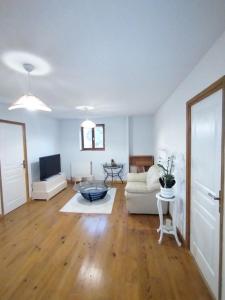 a living room with a couch and a table at Le Clos de Bourdeilles chambre 2 avec wifi in Bourdeilles