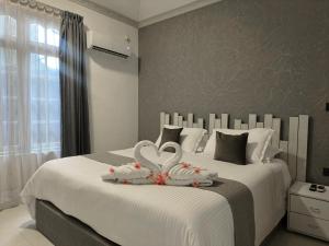 Postelja oz. postelje v sobi nastanitve Turtle Inn Dharavandhoo