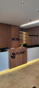 a rendering of a planetresbestos reception desk in a building at Planet Residence Royal Studio & SPA in Niš +70 photos