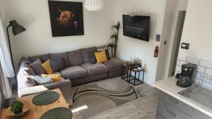 a living room with a couch and a table at Jaymar in Fife