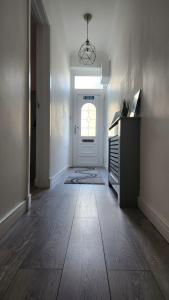 a room with a hallway with a door and a window at Jaymar in Fife