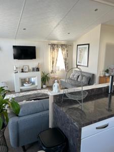 a living room with a couch and a table at Kent Getaways in Westgate-on-Sea
