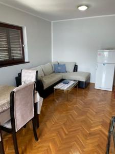 a living room with a couch and a table at Palma Baosici in Baošići