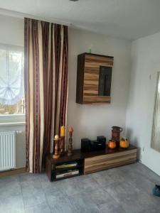 a living room with a tv on the wall at Siris Ferienhaus in Springstille +23 photos