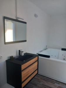 a bathroom with a sink and a bath tub at White and Cotton Suite in Saint-Paul-de-Fenouillet