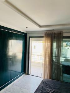 a bedroom with a large sliding glass door to a balcony at La Cascade Ḩammām al Ghazzāz in Kelibia +55 photos