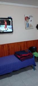 a room with a bed with a tv on the wall at Karylago in Casa Bamba +35 photos