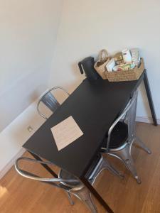 a black table with a basket on top of it at Svane's Air-bnb in Nykøbing Mors