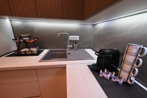 a kitchen with a sink and a counter at Creamy Dreams by Dazzie in Skopje +13 photos